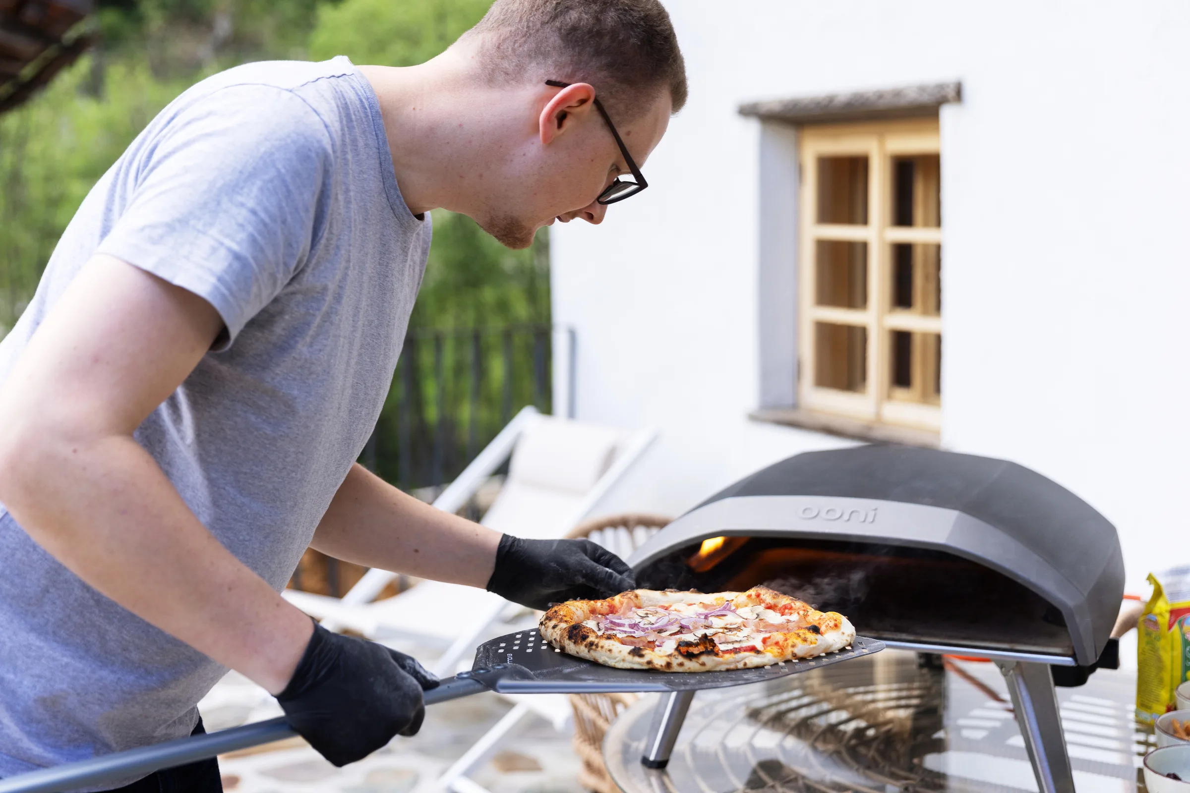codejoi team member baking pizza during an offsite