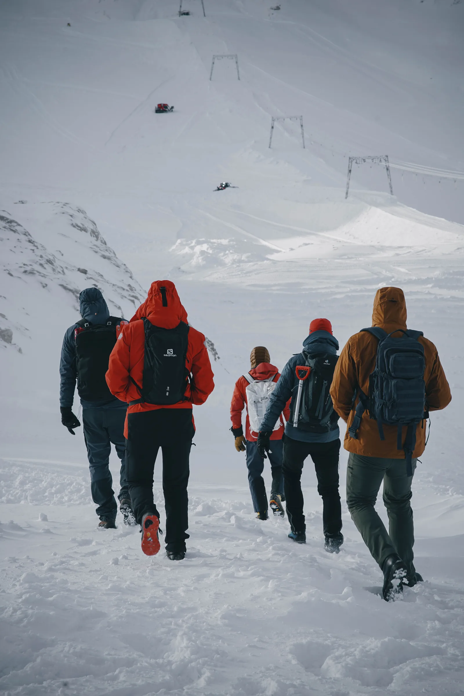 codejoi team members walking together through snow during a mountain offsite